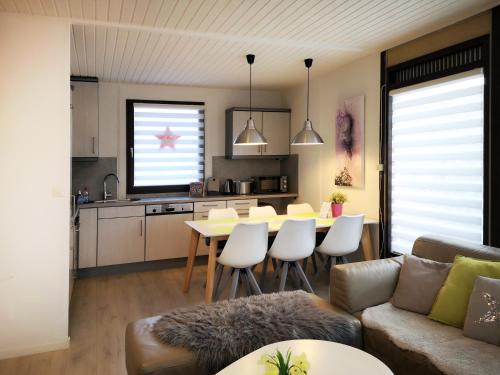 a kitchen and living room with a table and chairs at Ferienhaus IRENE in Meschede