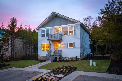 a white house with a balcony and a yard at Par-Tee Haus I- Game Room & Hot Tub-Walk to Helen in Helen