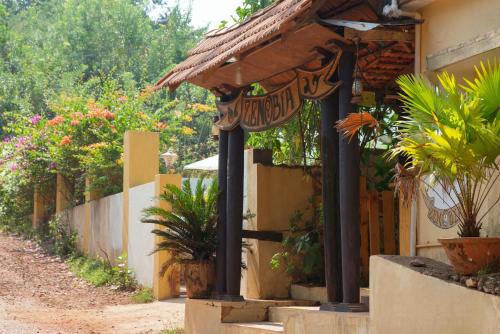 a building with a porch with potted plants on it at Zenobia Leisure in Anjuna