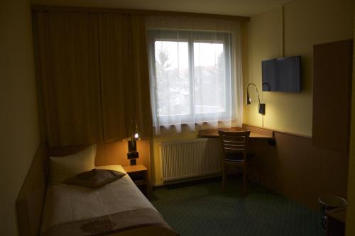 Postel nebo postele na pokoji v ubytování ACRON Hotel Wittenberg