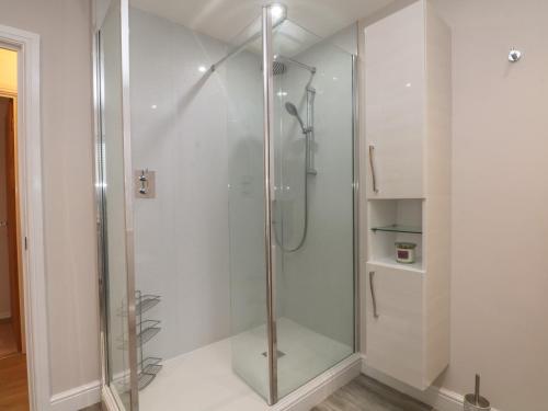 a shower with a glass door in a bathroom at 7 Marl Croft in Chester