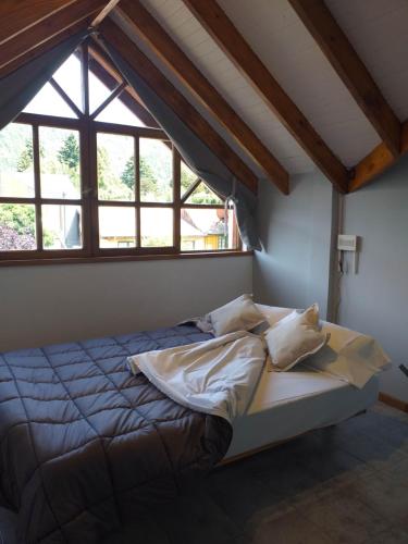 a bed in a room with a large window at Instantes in San Martín de los Andes