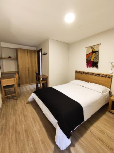 Ένα ή περισσότερα κρεβάτια σε δωμάτιο στο Hotel Casa Merced