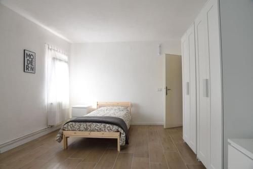 a small bedroom with a bed and a window at La Piccola Casa di Via Ricotti in Castelguglielmo