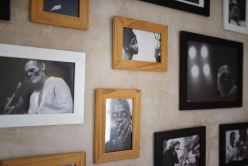 a wall with pictures of people on it at La Piccola Casa di Via Ricotti in Castelguglielmo