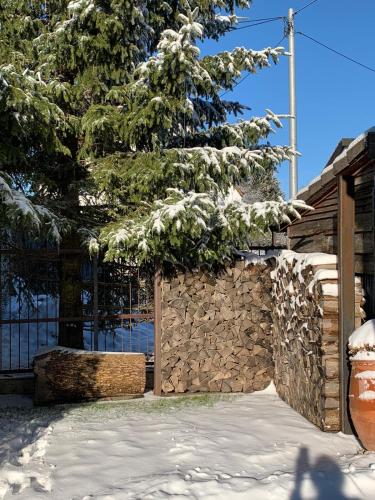 Una cerca de piedra con un árbol encima. en ALB-APARTMENT-WESTERHEIM Kurort, en Westerheim