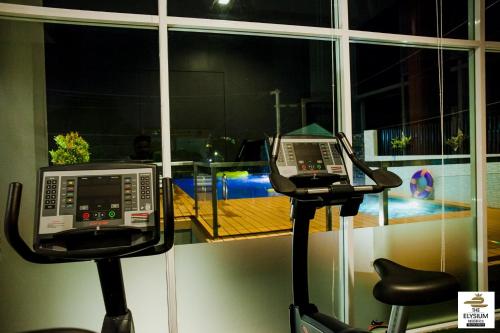 a gym with a phone and two exercise bikes at The Elysium Residence - SHA Extra Plus in Chalong 