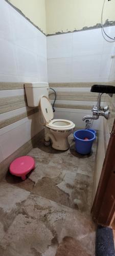 a bathroom with a toilet in a room at Swapnpurti yatri niwas in Kolhapur
