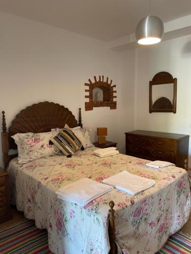 a bedroom with a large bed and a mirror at 9Arches in Vila Nova de Poiares