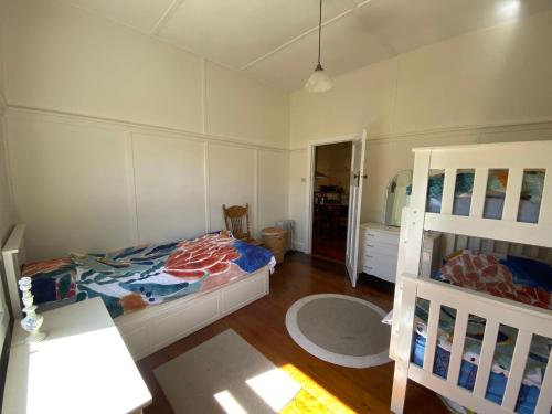 a small bedroom with a bed and a mirror at Edwardian Getaway in Wonthaggi