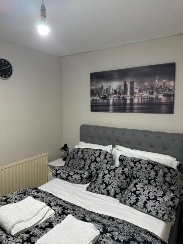 a bedroom with a bed with a black and white at Beautiful First Floor one bedroom apartment B Walthamstow in London