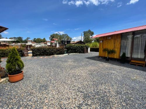 a gravel driveway in front of a building at Glamping en villa in Villa de Leyva
