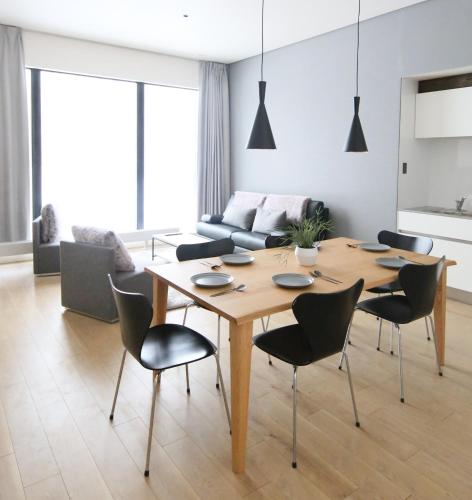 a living room with a wooden table and chairs at Niseko Bisha 美舎 Villas in Niseko