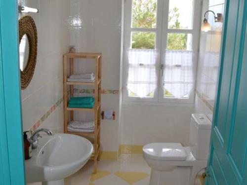 a bathroom with a sink and a toilet and a window at Gîte Seuilly, 7 pièces, 10 personnes - FR-1-381-67 in Seuilly