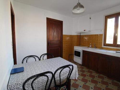 une cuisine avec une table et des chaises et une cuisine avec un évier dans l'établissement Appartement typique au cœur de Collioure, proche plages, commerces et sites historiques - FR-1-309-269, à Collioure