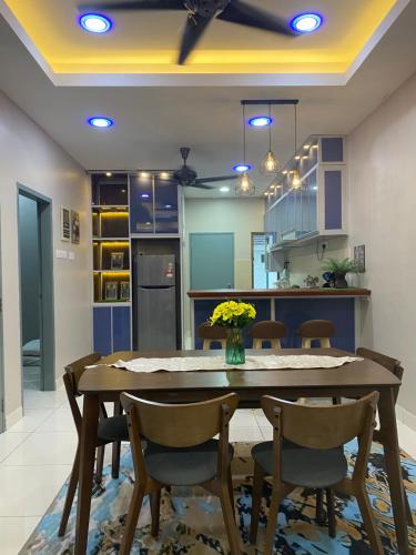 a kitchen with a dining room table and chairs at Ana Homestay BP Free Netflix, WiFi, Mountain View, Playground, 5 Car Park & Guard Near To Uthm, Kpj, Ipg, Kptm, Kktm, Adtec And Bp City by Host Hani Hamizan in Batu Pahat
