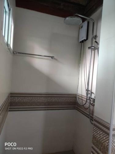 a bathroom with a shower with a shower head at tamarind guesthouse in Phra Nakhon Si Ayutthaya