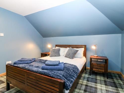 a bedroom with a bed with two blue towels on it at The Cavern at the Tavern in Blairgowrie