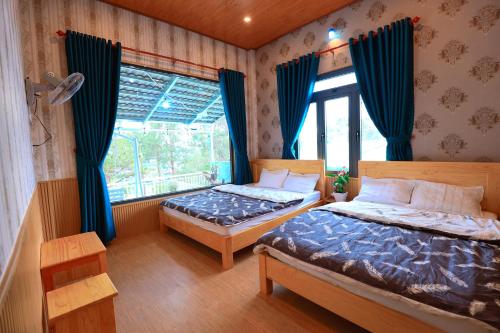 a bedroom with two beds and a window at Cẩm Tú Villa Đà Lạt in Da Lat