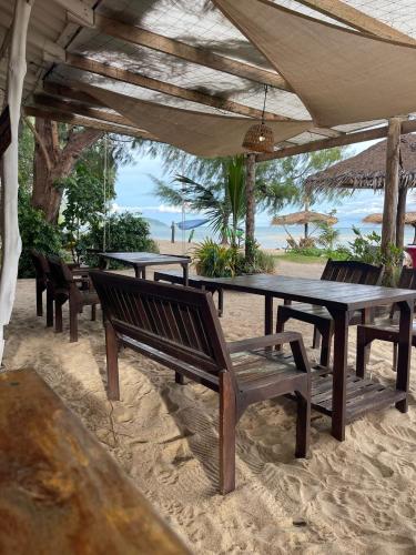 a group of tables and benches on the beach at SeaEsta Beach in Baan Tai