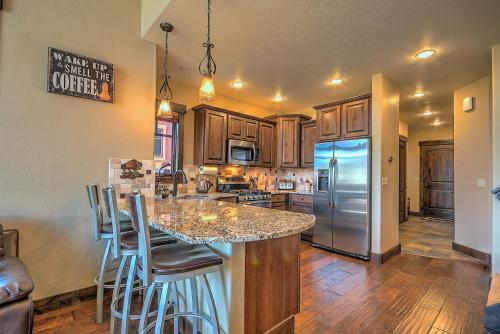 a kitchen with a large island with bar stools at 5-Star Finishings Townhome, Minutes from World Class Ski Resorts, Hot Tub home in Silverthorne
