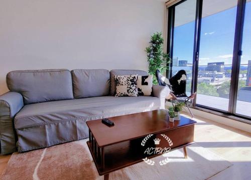 a living room with a couch and a coffee table at CBD High level City View 1BR Apt Free parking in Canberra