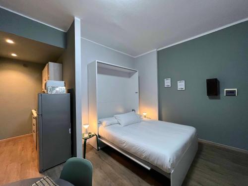 a small bedroom with a bed and a chair at Giano Host - Ponterotto in Genova