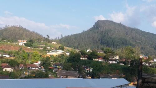 a town on a hill with a mountain at KPL Holiday Homes in Hatton