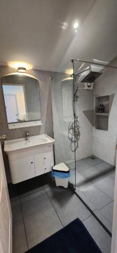 a bathroom with a sink and a shower at The Nidhra Boutique Resort in Baan Tai