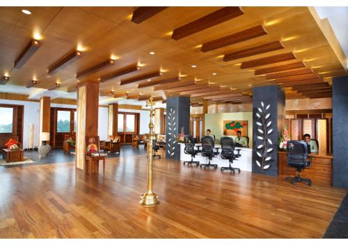 a large lobby with desks and chairs in a building at Chandys Windy Woods Munnar in Munnar