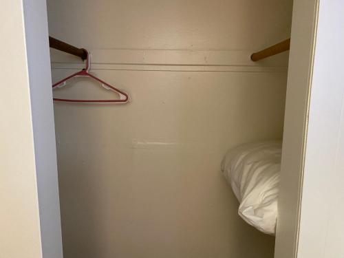 a small closet with a bed and a hanger at RANGER MOTEL in Cheyenne