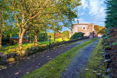 a dirt road in front of a stone building at The Keep at Craigiehall in Edinburgh
