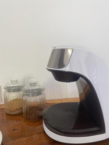 a toaster sitting on a table next to jars of food at Amila Dive Beach Resort in Sipalay