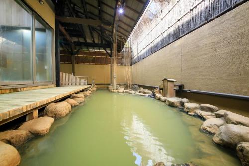 a large pool of water in a building with rocks at Yutorelo Toyako in Lake Toya