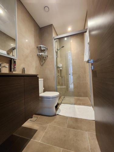a bathroom with a toilet and a glass shower at STAY BY LATINEM Luxury 2BR Holiday Home CV B1614 near Burj Khalifa in Dubai