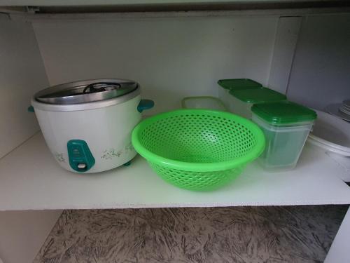 a shelf with two baskets and a pot and a bowl at Cosy 2 bedroom unit with pool,Wifi in Suva