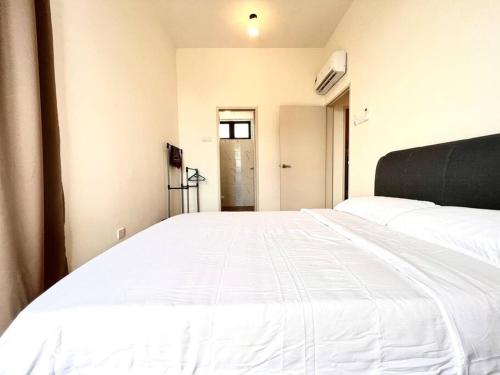a large white bed in a room with a door at Ins Suite @ The Quartz Residence-Infinity Pool in Melaka