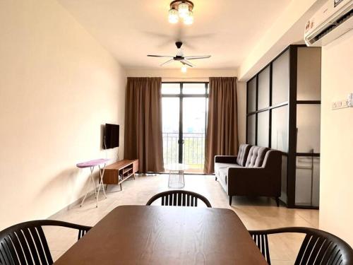a living room with a table and chairs and a couch at Ins Suite @ The Quartz Residence-Infinity Pool in Melaka