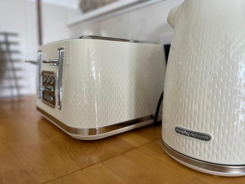 a toaster sitting on top of a wooden table at Parc Farm Cottage, Flintshire, North Wales in Rhydymwyn