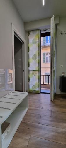 an empty room with a door open to a balcony at IO E TE bed and breakfast Appartamento in Cuneo