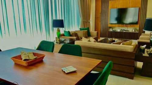 a living room with a table and a couch at 2 Bed Royal in Murree