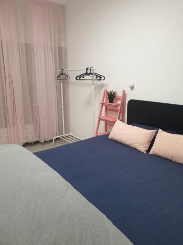a bedroom with a bed and a red chair at חצבים על הואדי in Arad