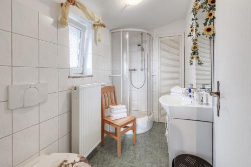 a white bathroom with a sink and a toilet at Ferienwohnung " Müritzblick " in Waren