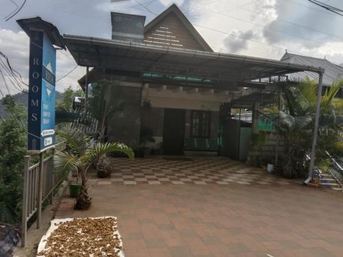 a building with a sign in front of it at Riya Home Stay Munnar in Anaviratty
