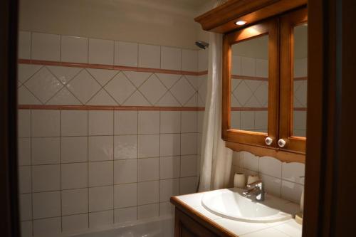 a bathroom with a sink and a mirror and a tub at 2 bedroom Apartment in Les Houches Stone's throw from Prairon lift in Les Houches