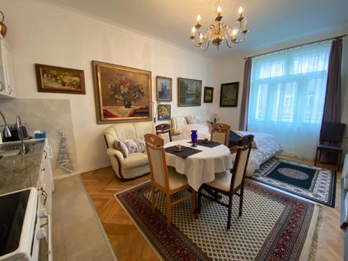 a kitchen and living room with a table and chairs at Slavikova-DeLuxe+ in Prague