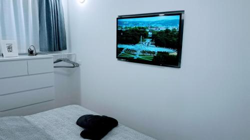 a living room with a flat screen tv on the wall at Studio Apartment Nani Centar in Split