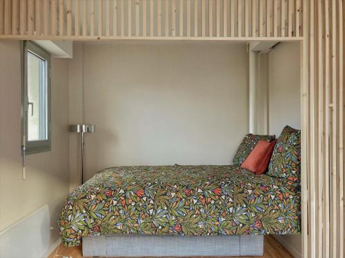 a bedroom with a bed with a bed frame at Studio proche plage balcon et parking in Deauville