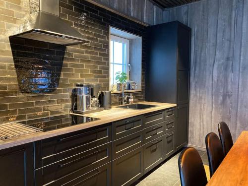 a kitchen with a sink and a counter top at Modern Stuga med Ski Lodge känsla in Järvsö