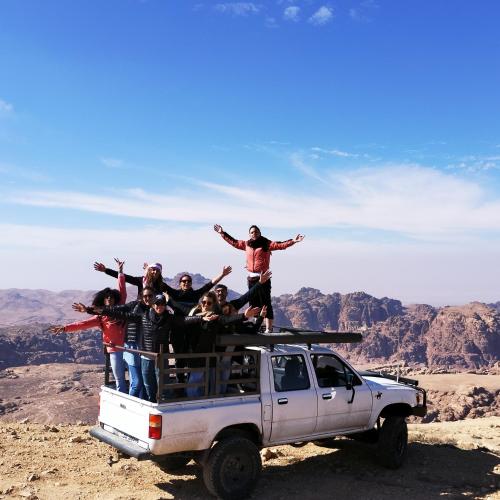 a group of people standing on the back of a truck at Petra Desert Dream Hotel in Wadi Musa